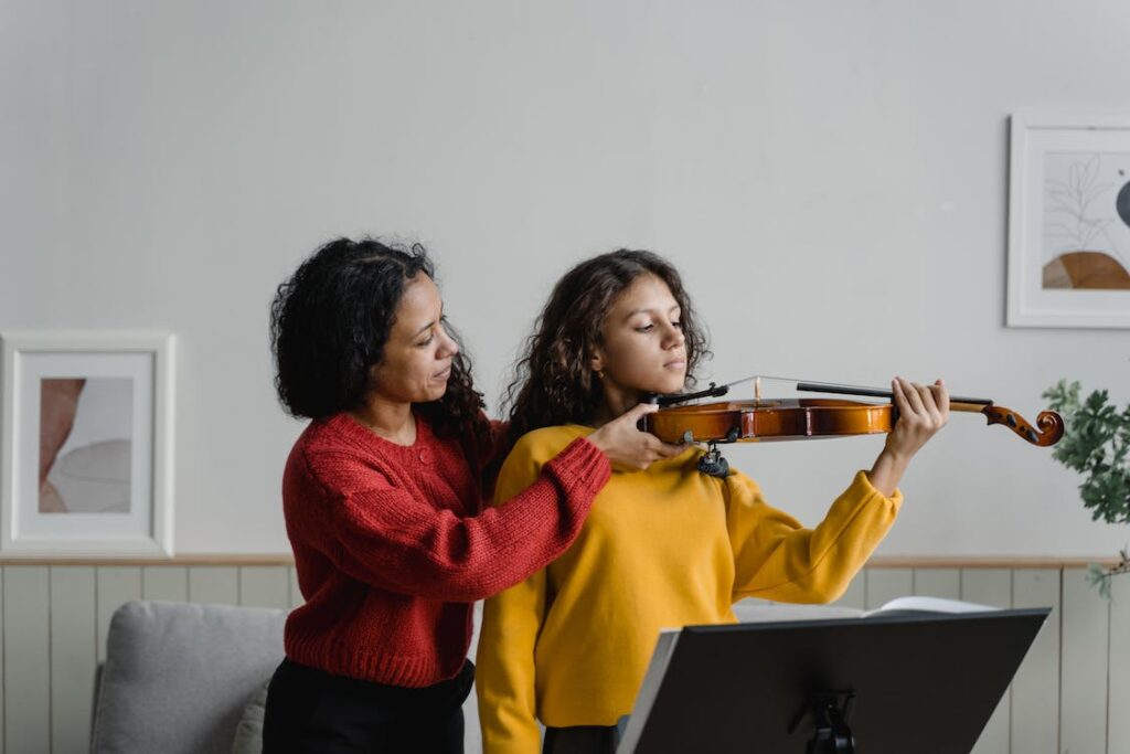 Girl being sized for violin, positioning of violin, teaching violin, Choosing the Right Size String Instrument